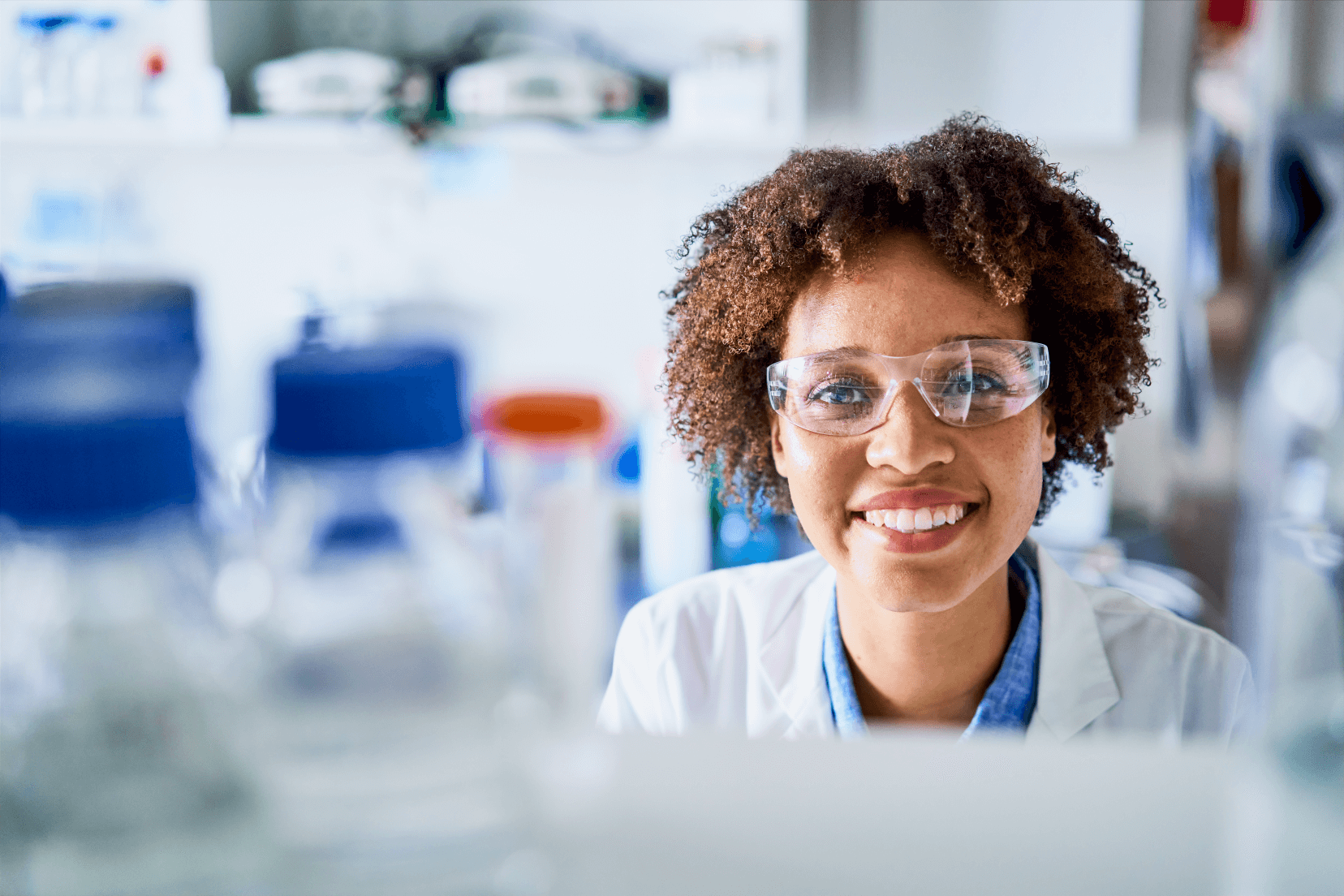 Laboratory employee engaging with camera